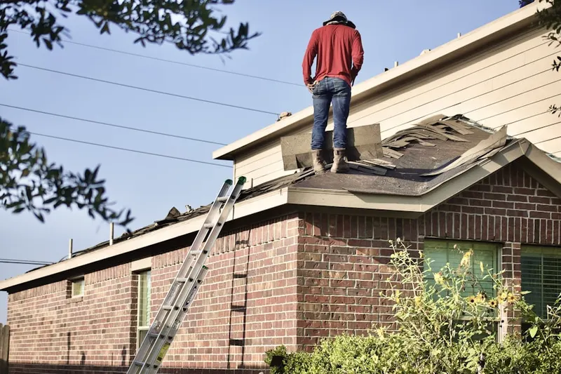 Professional roofer working on a residential roof in Martin Crossing
